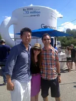 3 people standing in front of a giant cup.